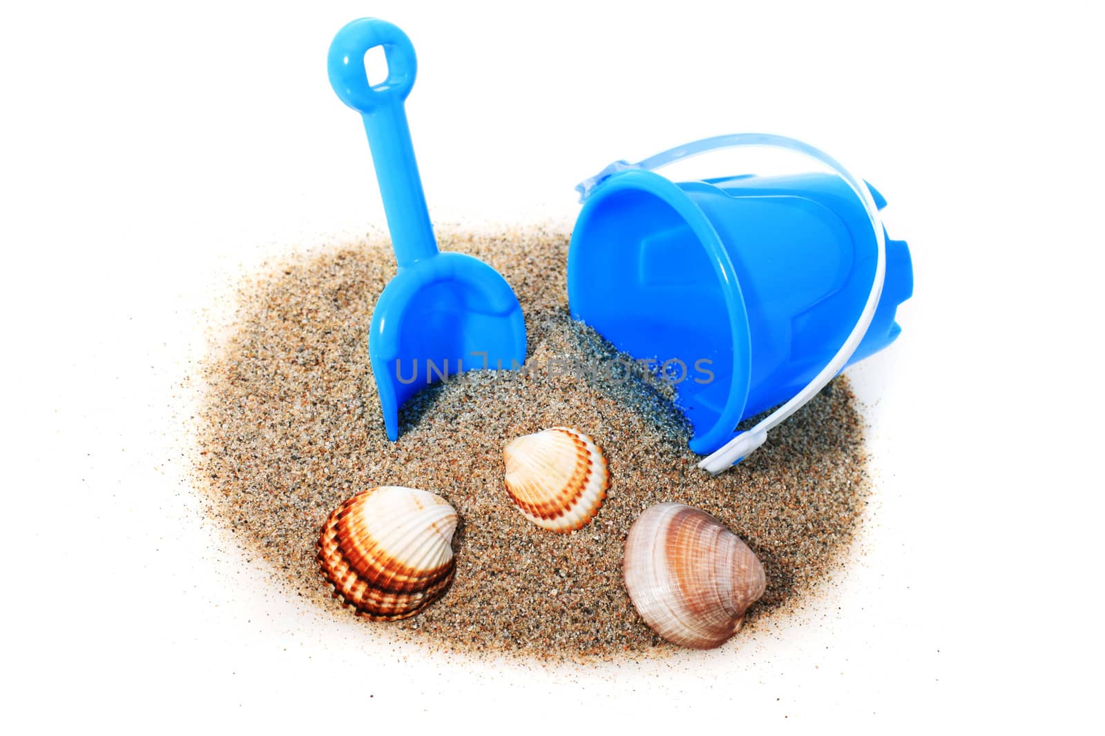 Toys and sand isolated over white.