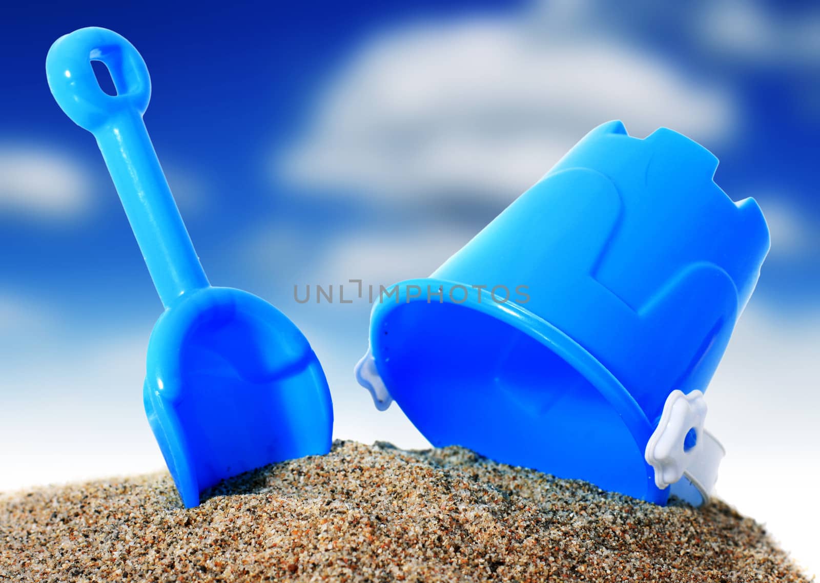 Toys and sand isolated over white background.
