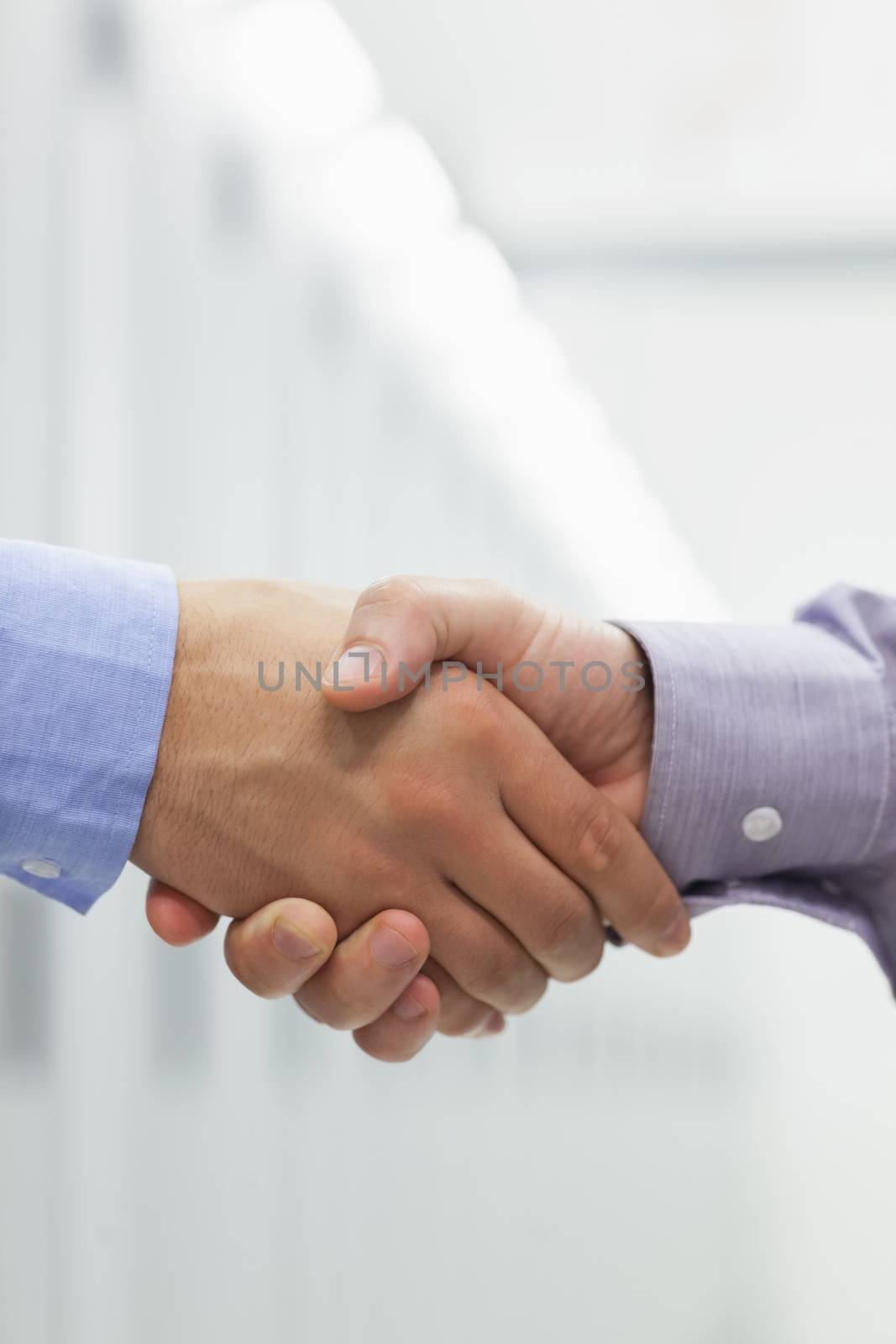 Two men shaking hands in hallway of data center