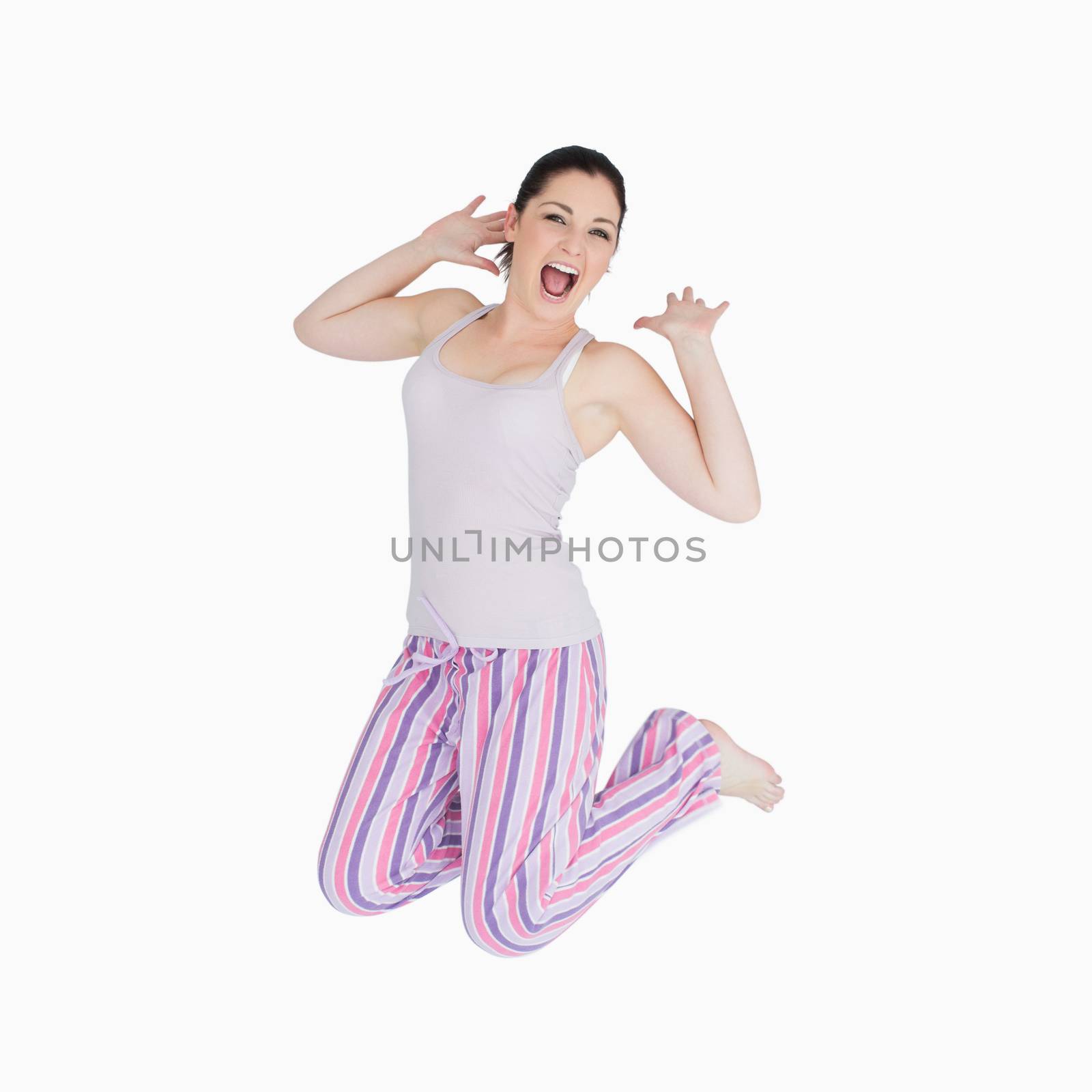 Yawning and stretching woman in pyjamas on the floor 