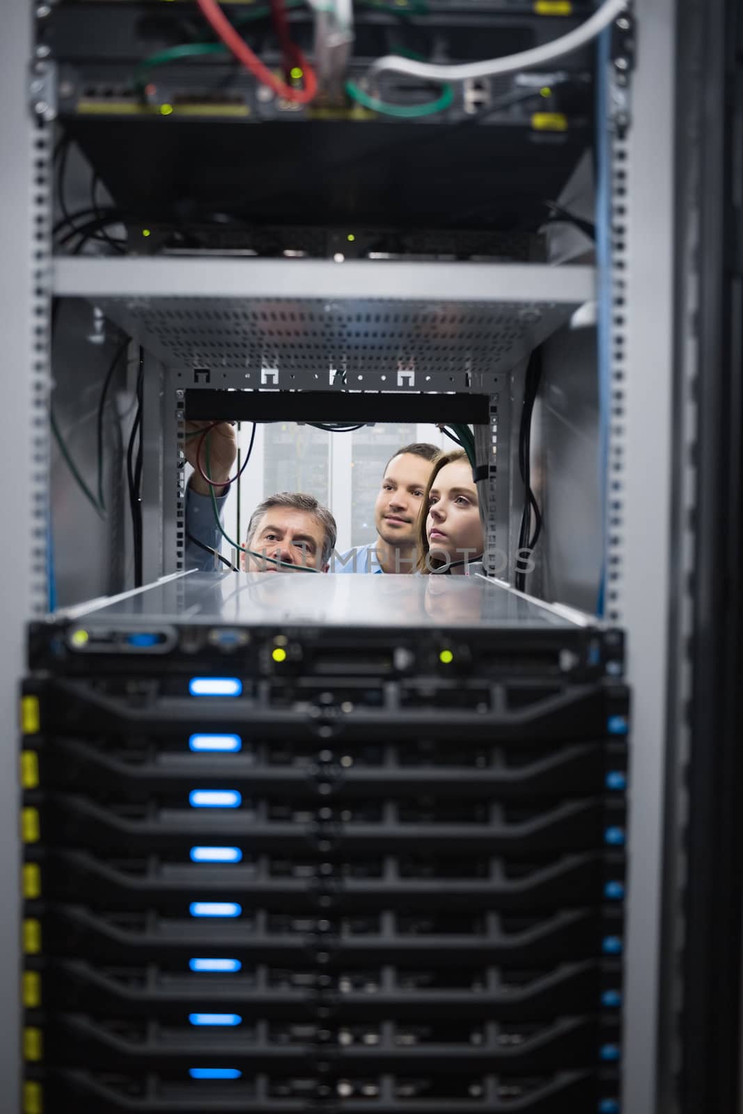 Tehnicians looking into servers in data center