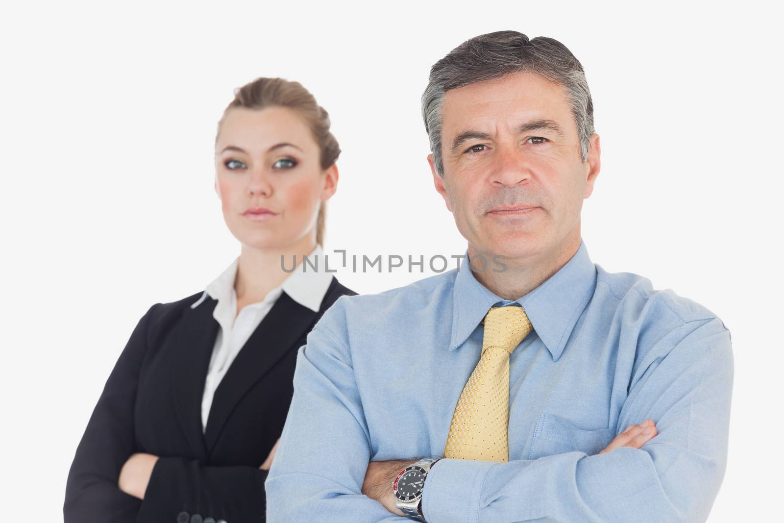 Portrait of confident business people with arms crosssed against white background