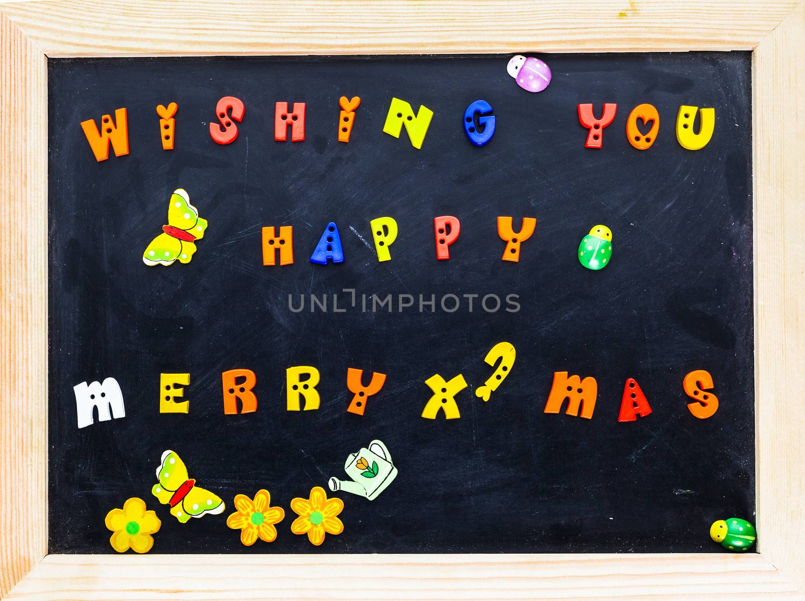 Color merry christmas words on black board.