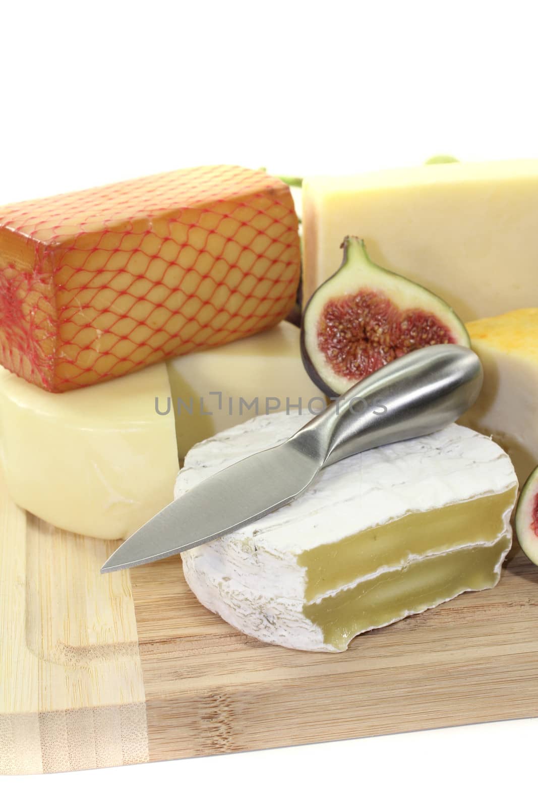 Selection of cheese with knife and fig
