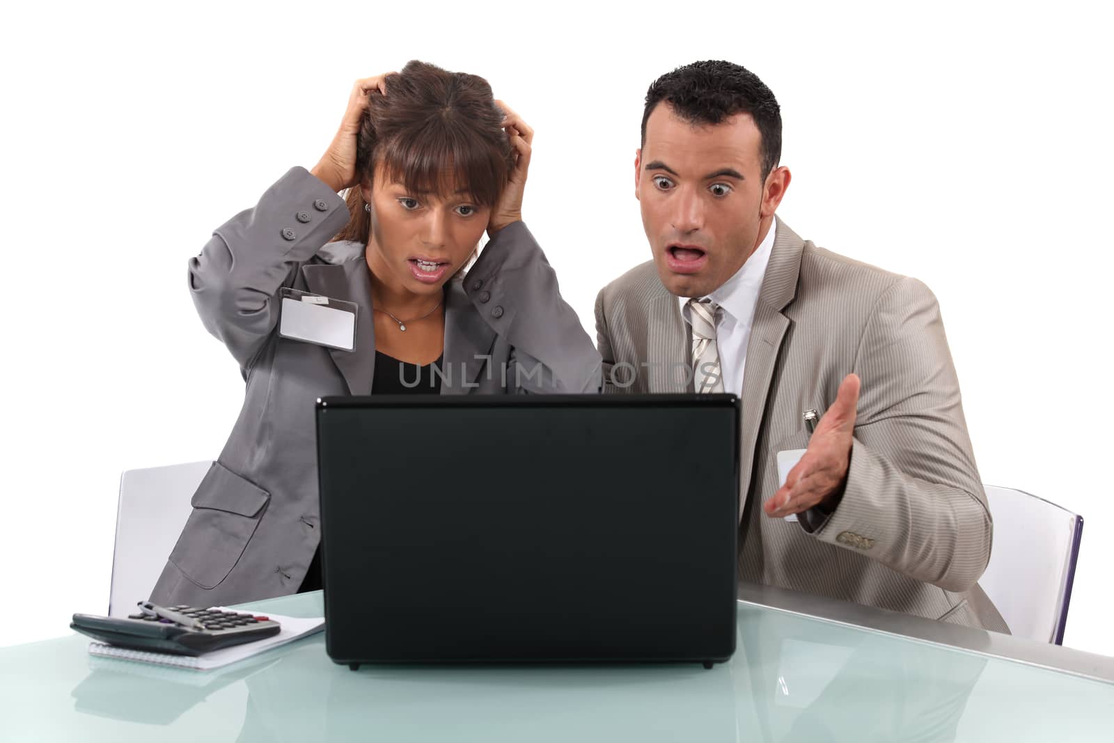 Two business people shocked by laptop