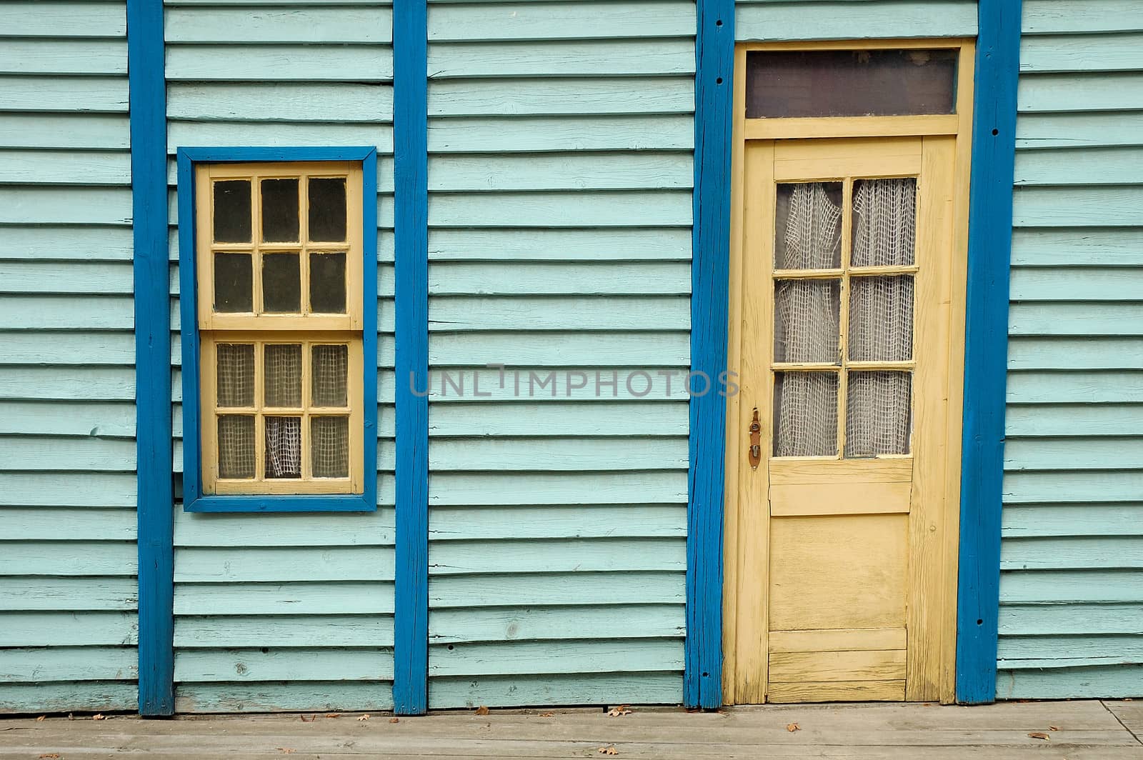 Blue wooden wall with window and door