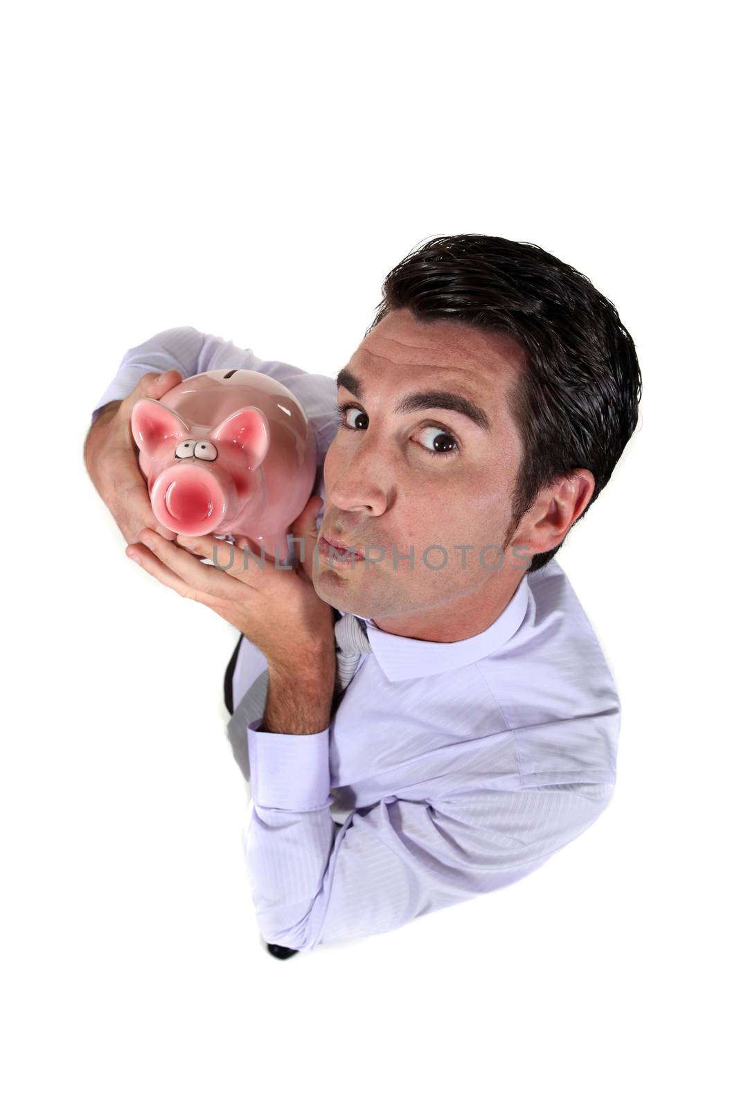 Man holding a piggy bank by phovoir