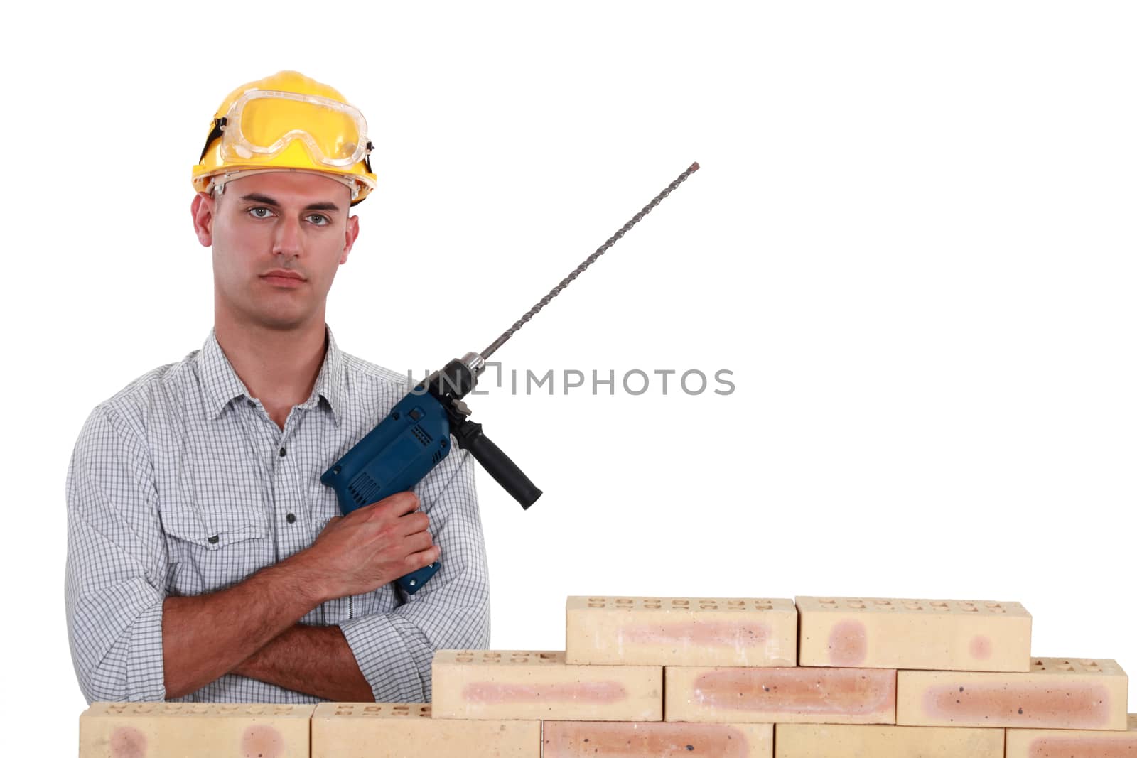 A mason holding a drill. by phovoir