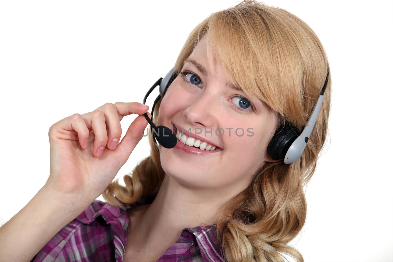 A blond woman with a headset on.