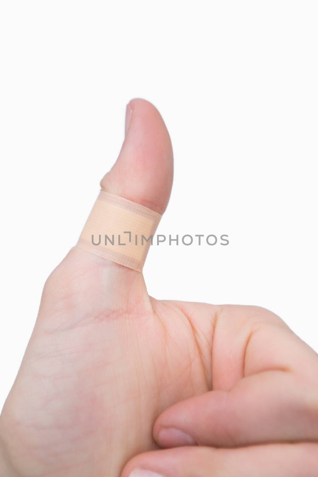 Closeup of thumbs up sign over white background