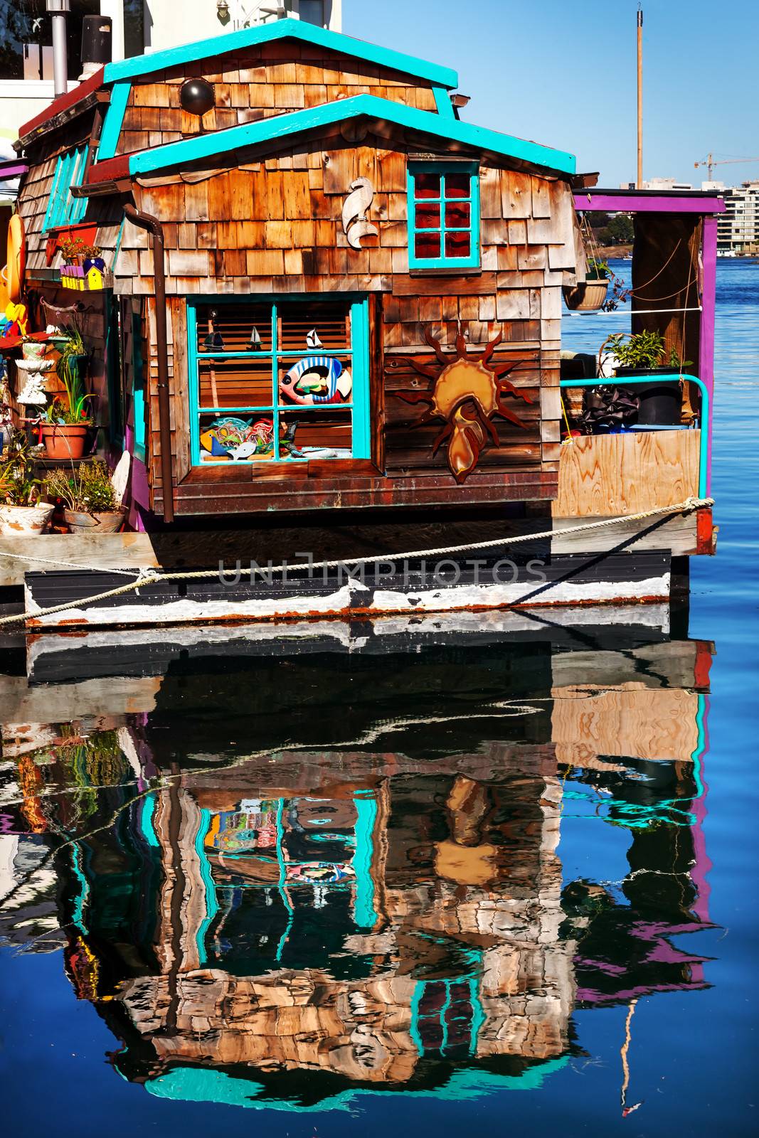 Floating Home Village Brown Houseboat Fisherman's Wharf Reflection Inner Harbor, Victoria Vancouver British Columbia Canada Pacific Northwest.  Close to the center of Victoria, this area has floating homes, boats, piers, and restaurants.