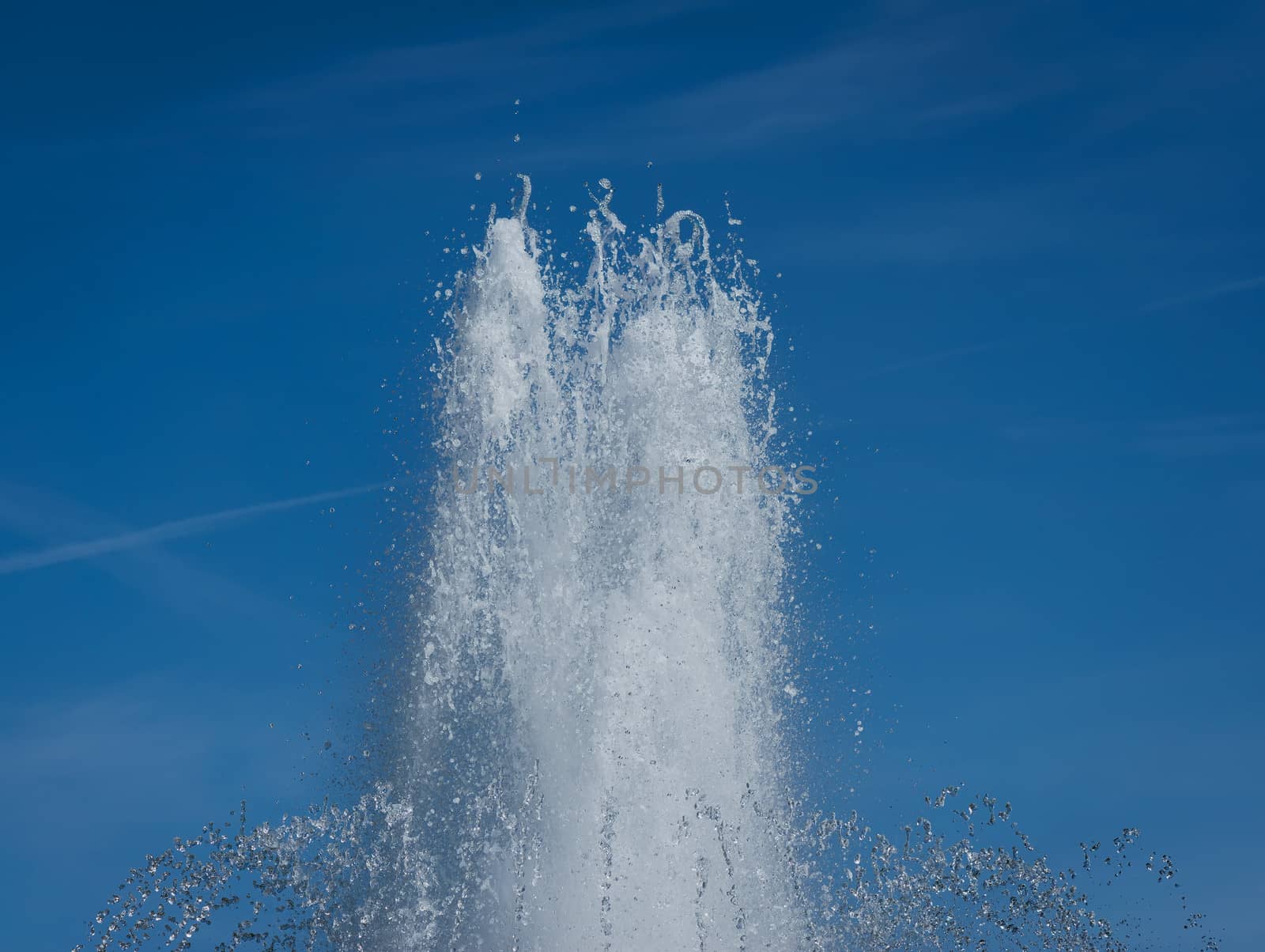 Water splash in fountain on blue sky background