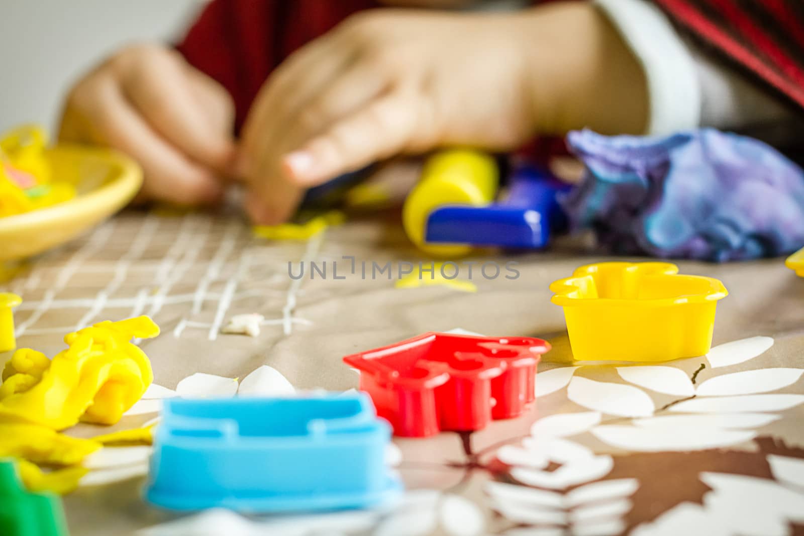 Closeup of plasticine molds and child hands on the background by doble.d