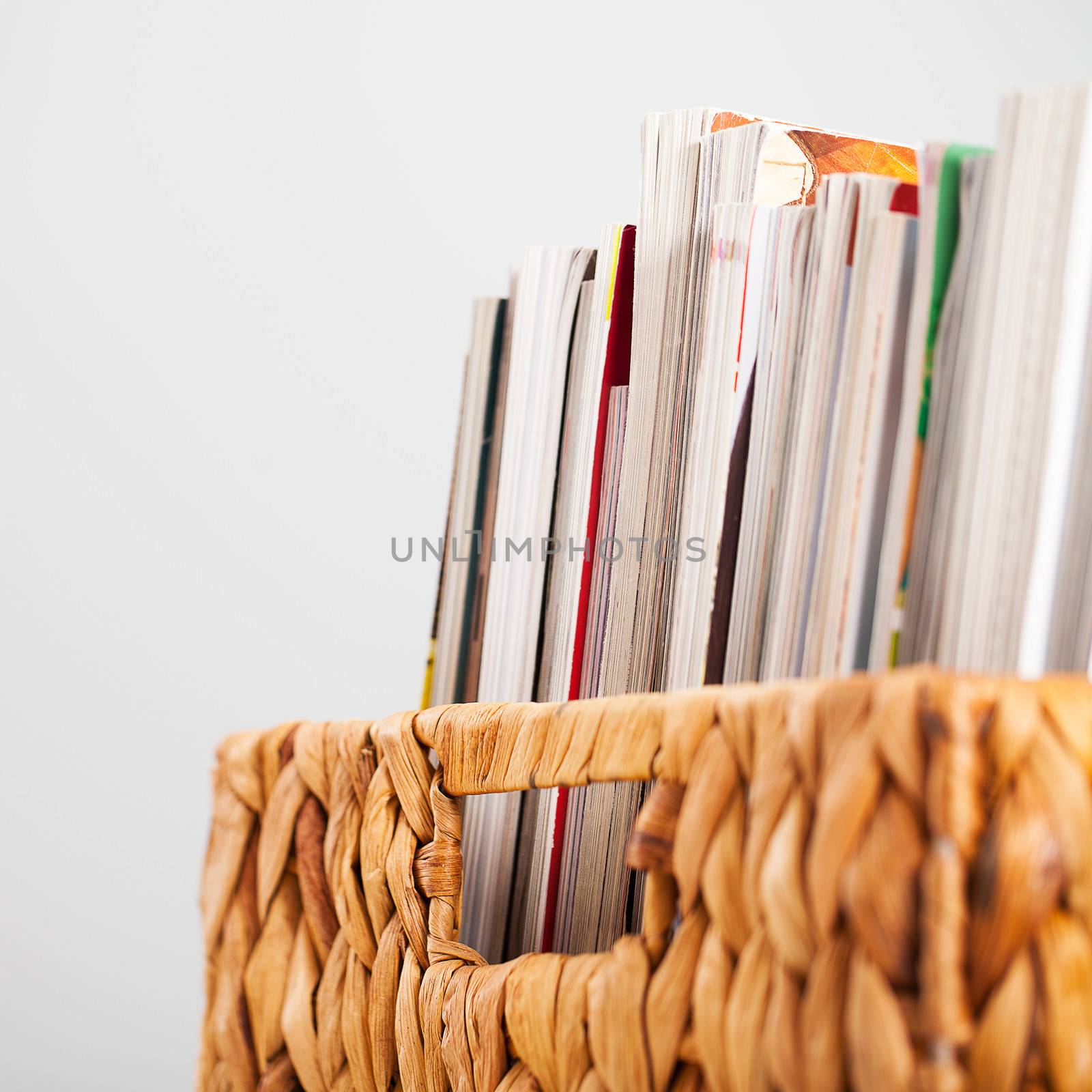 Closeup image of magazines in a straw pleated box