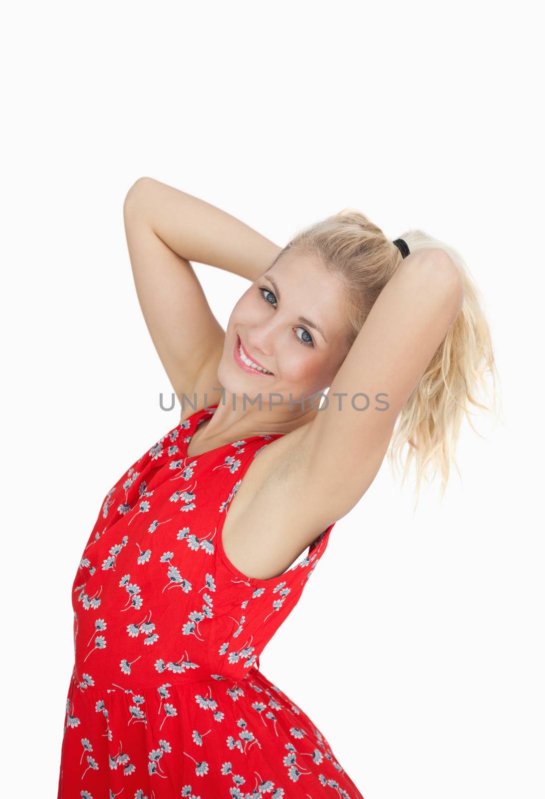 Portrait of young woman in red summer dress standing over white background