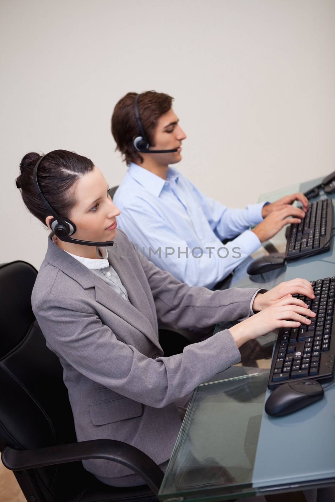 Side view of call center employees at work