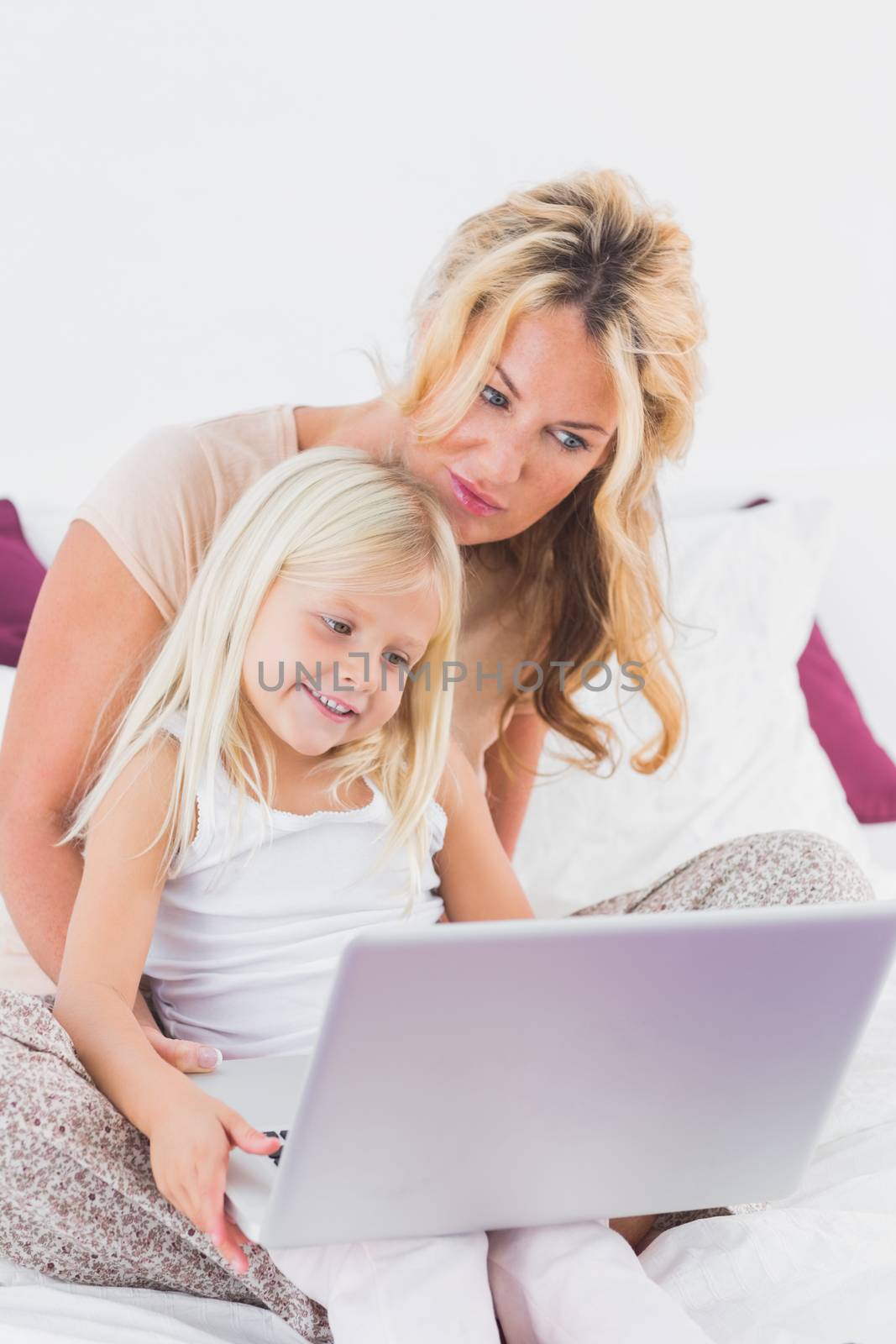 Mother and her daughter using a laptop by Wavebreakmedia