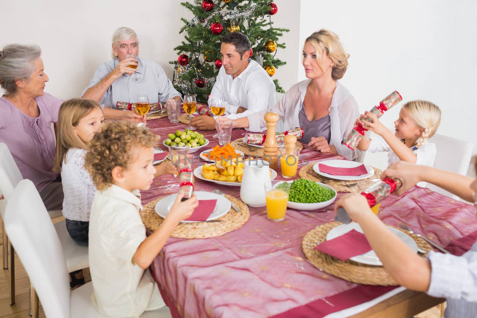 Family having christmas dinner together at table in kitchen