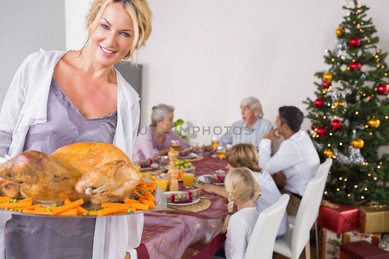 Proud mother showing roast turkey by Wavebreakmedia