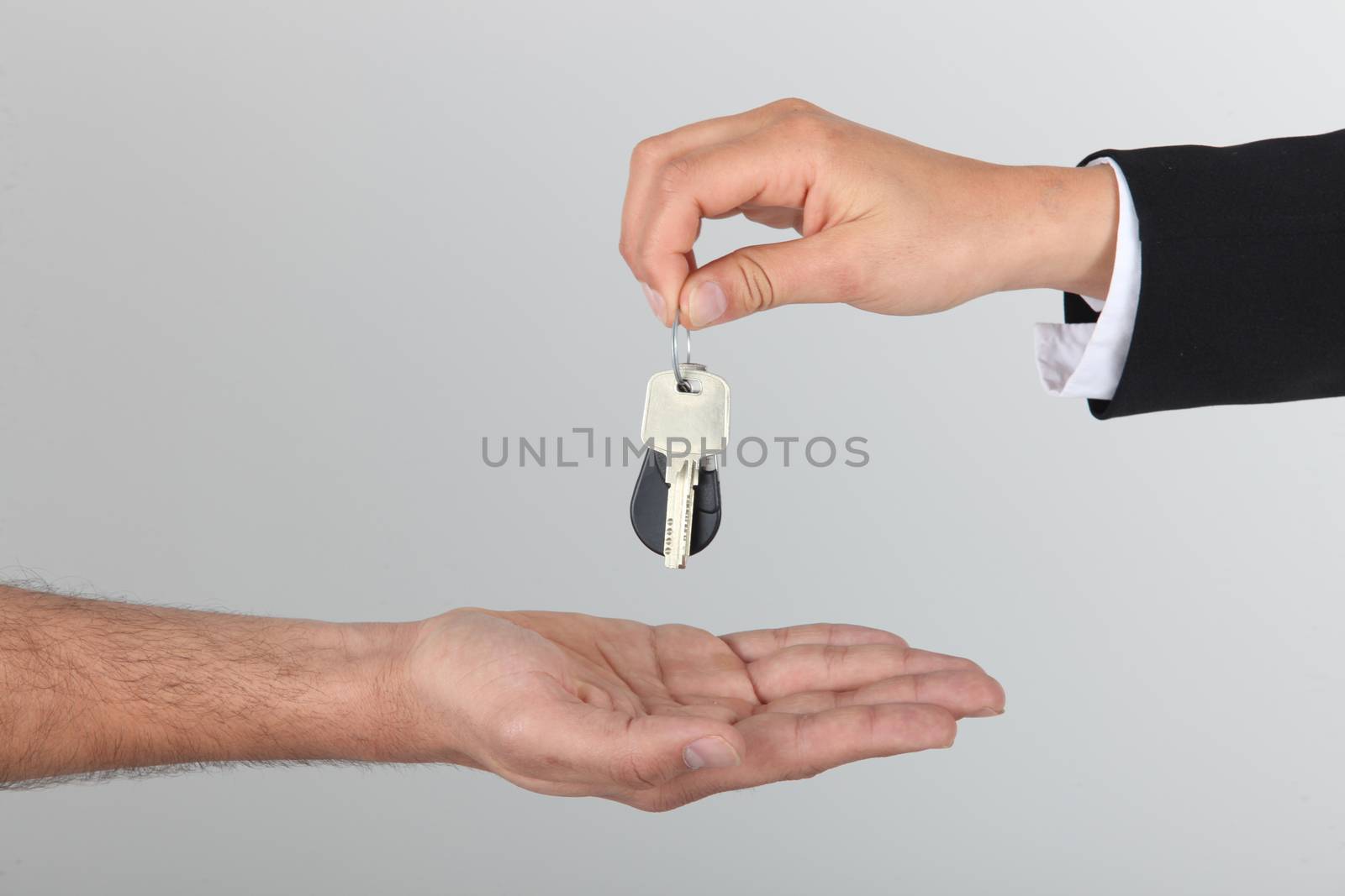 Estate agent handing over keys by phovoir