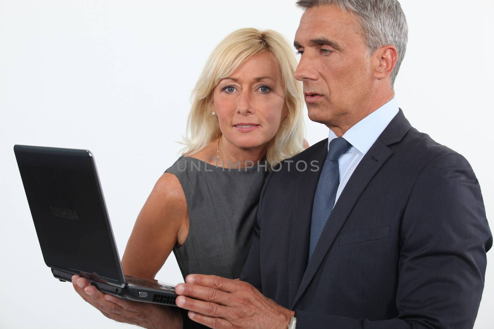 mature business couple posing by phovoir