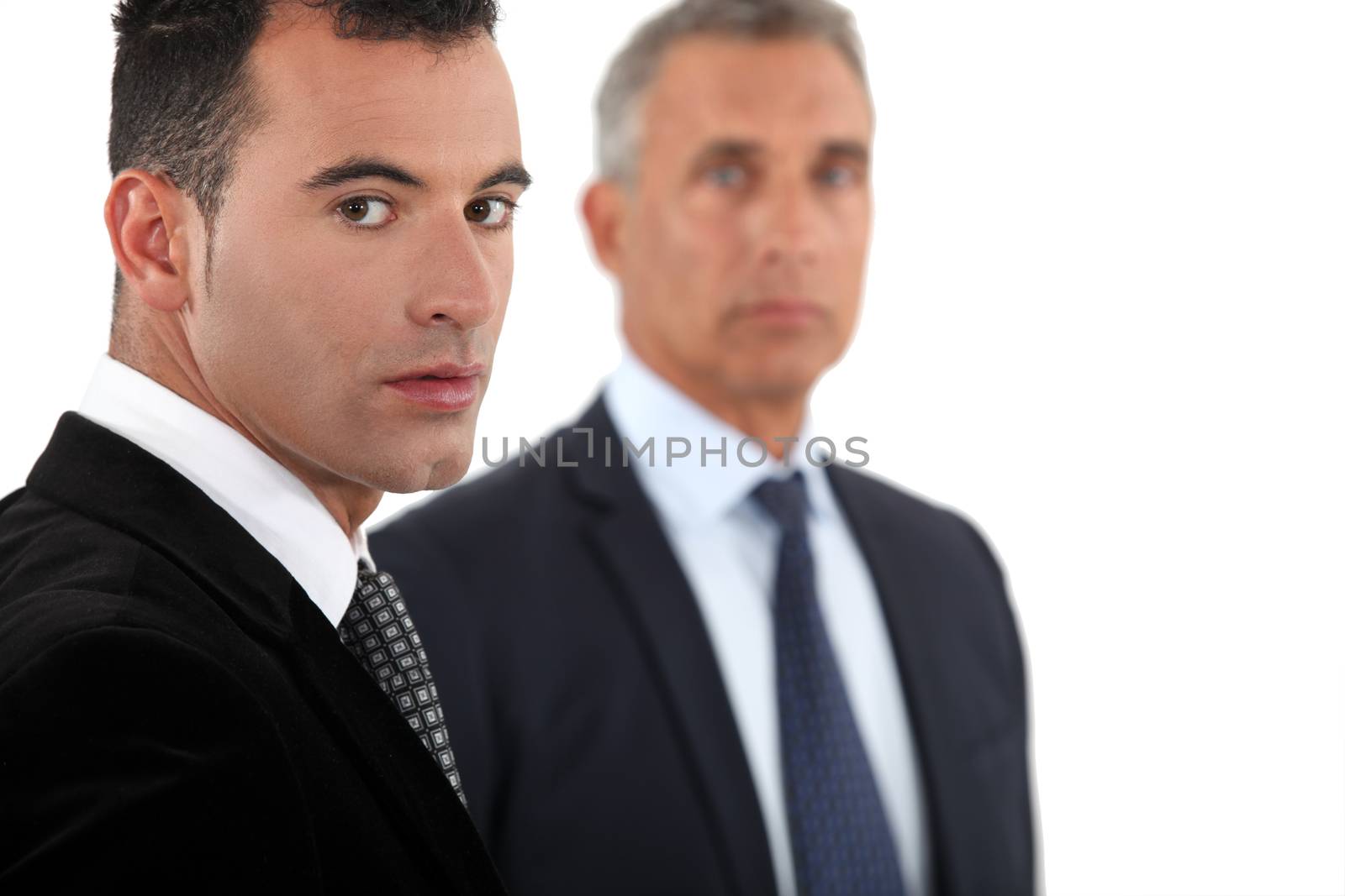 Serious businessman and an older colleague by phovoir