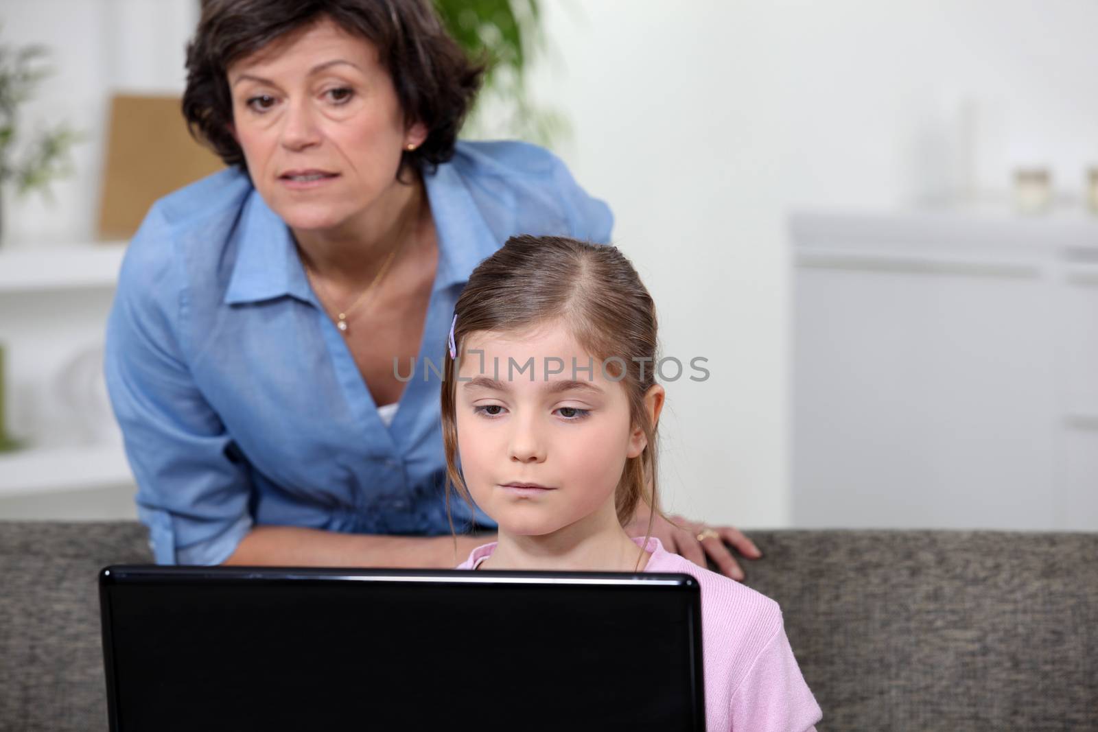 Woman and girl looking at a laptop computer