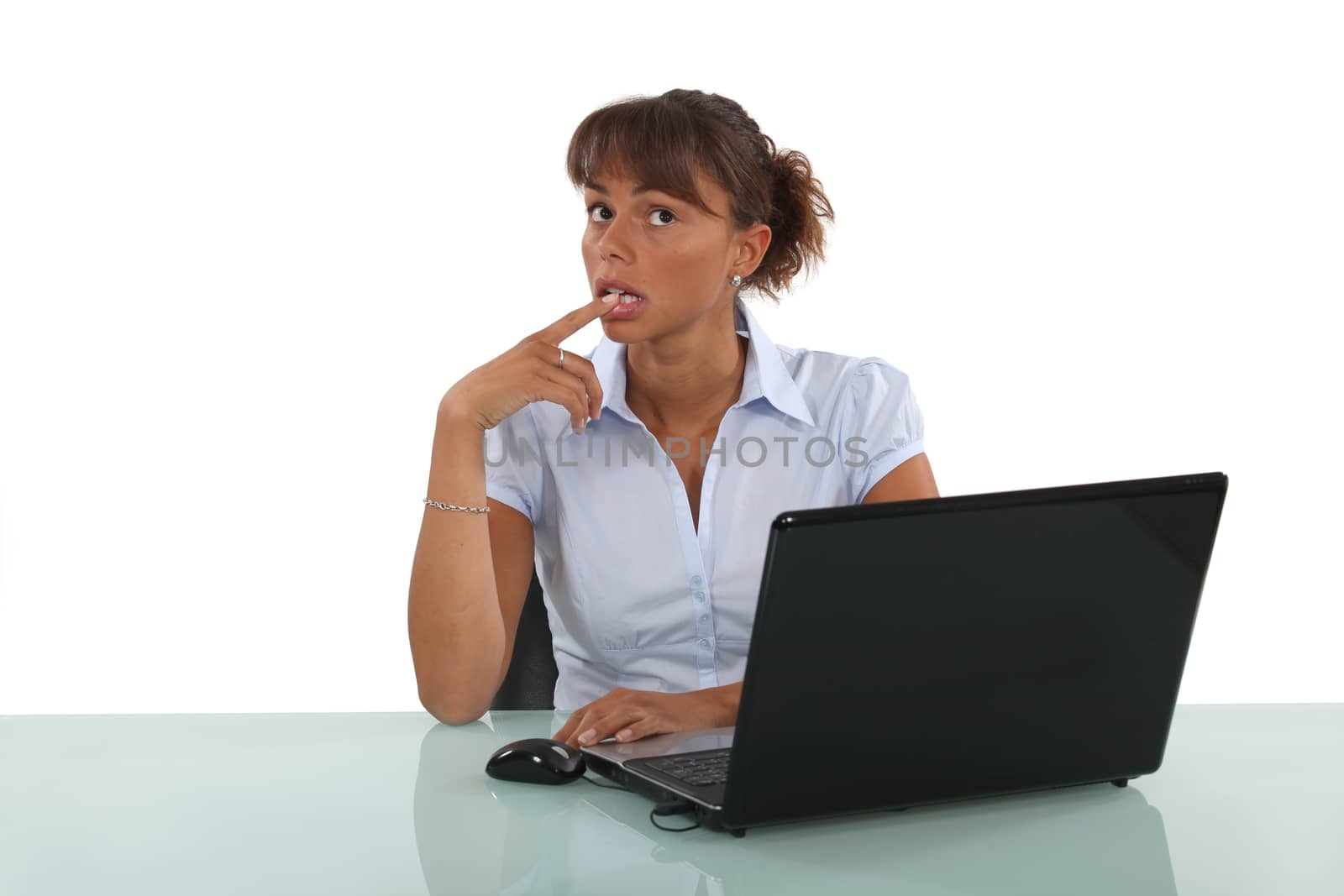 businesswoman sitting at her desk and thinking by phovoir