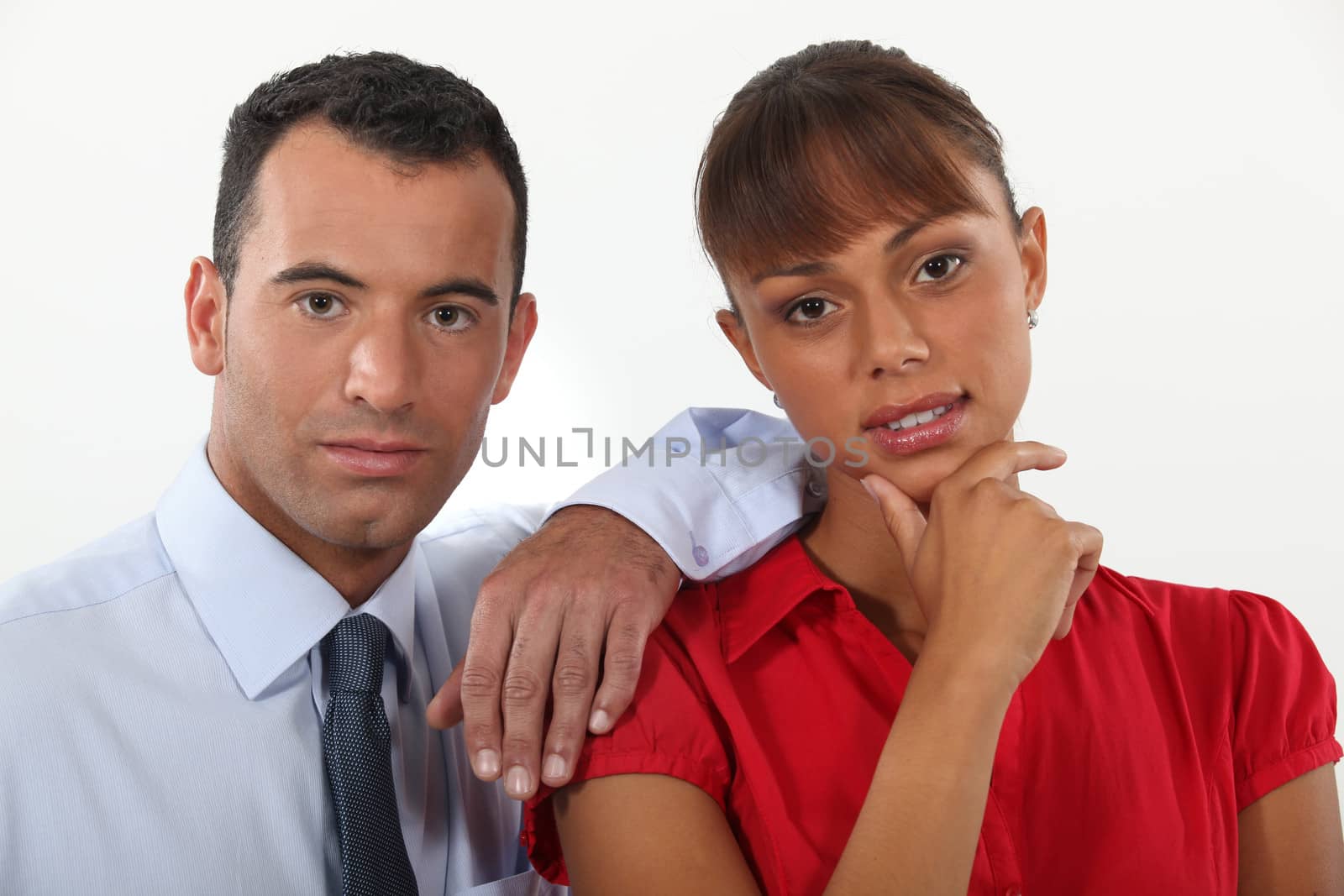 young businessman and businesswoman posing together by phovoir