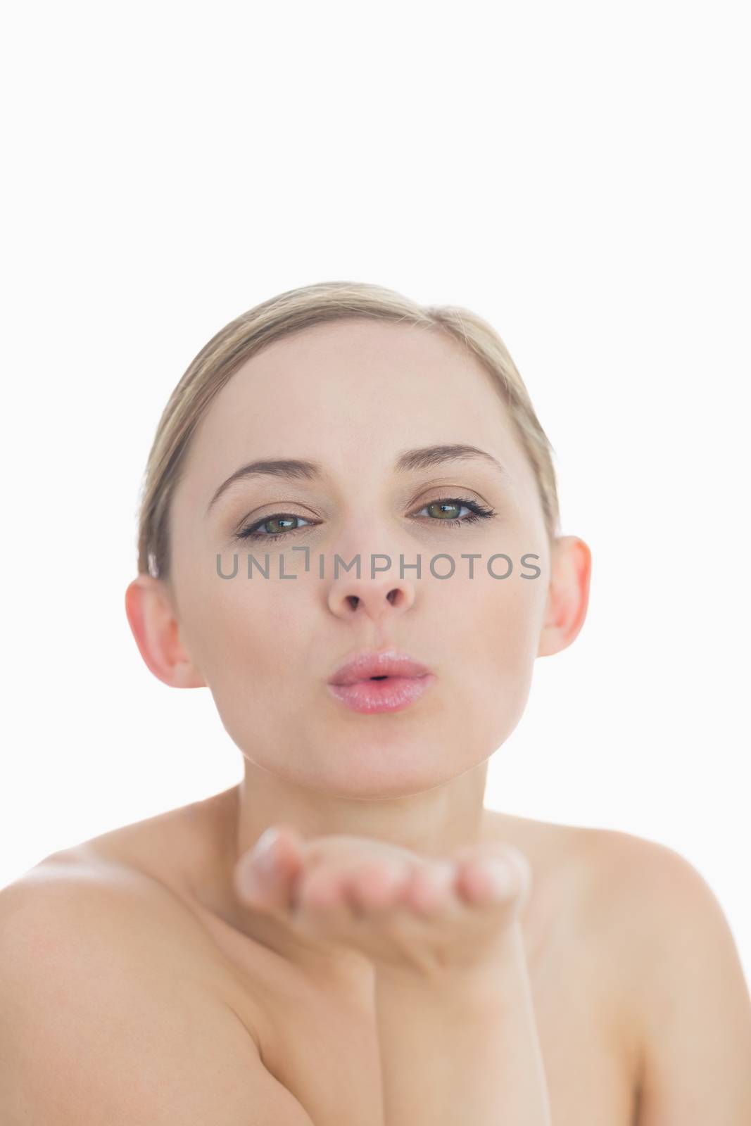 Closeup of cute young woman blowing a kiss by Wavebreakmedia