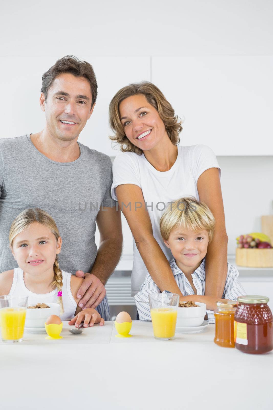 Smiling family at breakfast in the kitchen