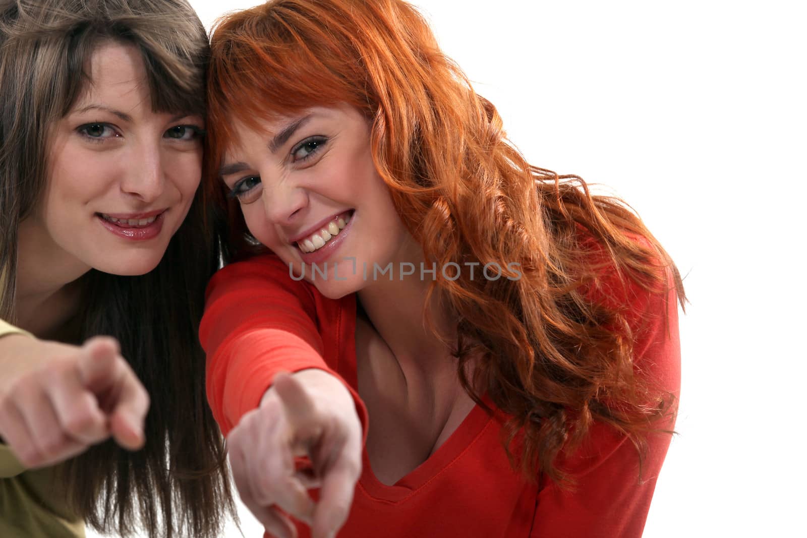 Two friends pointing at the camera.