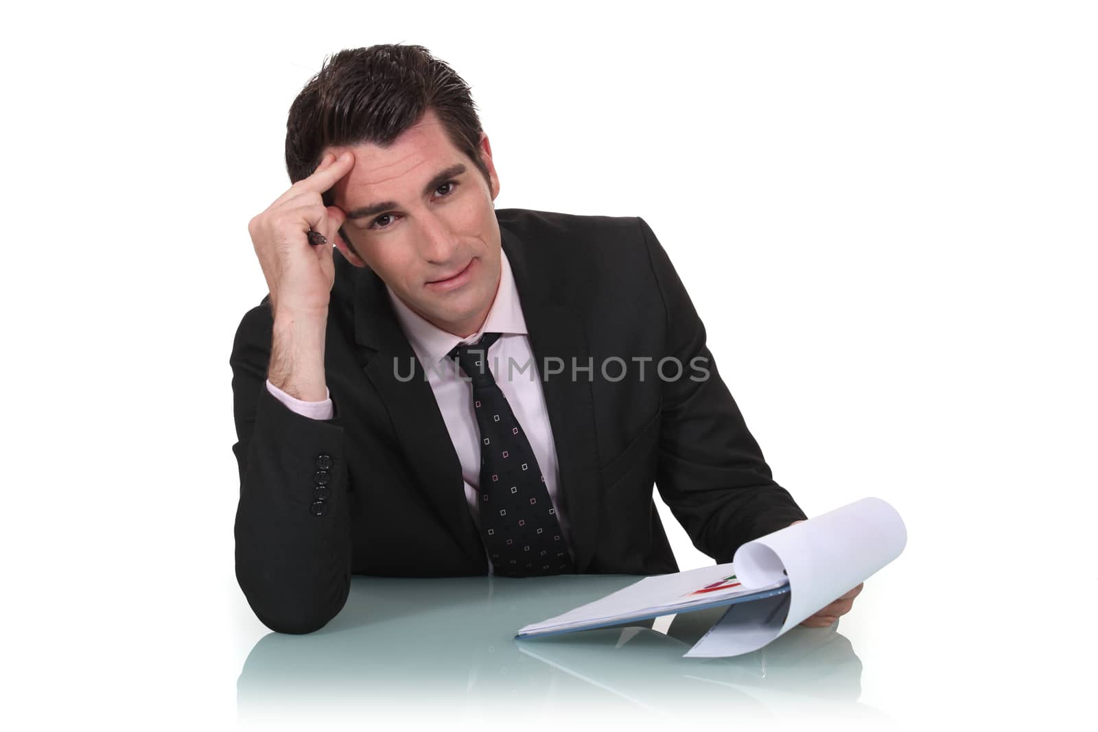 Businessman holding clipboard by phovoir