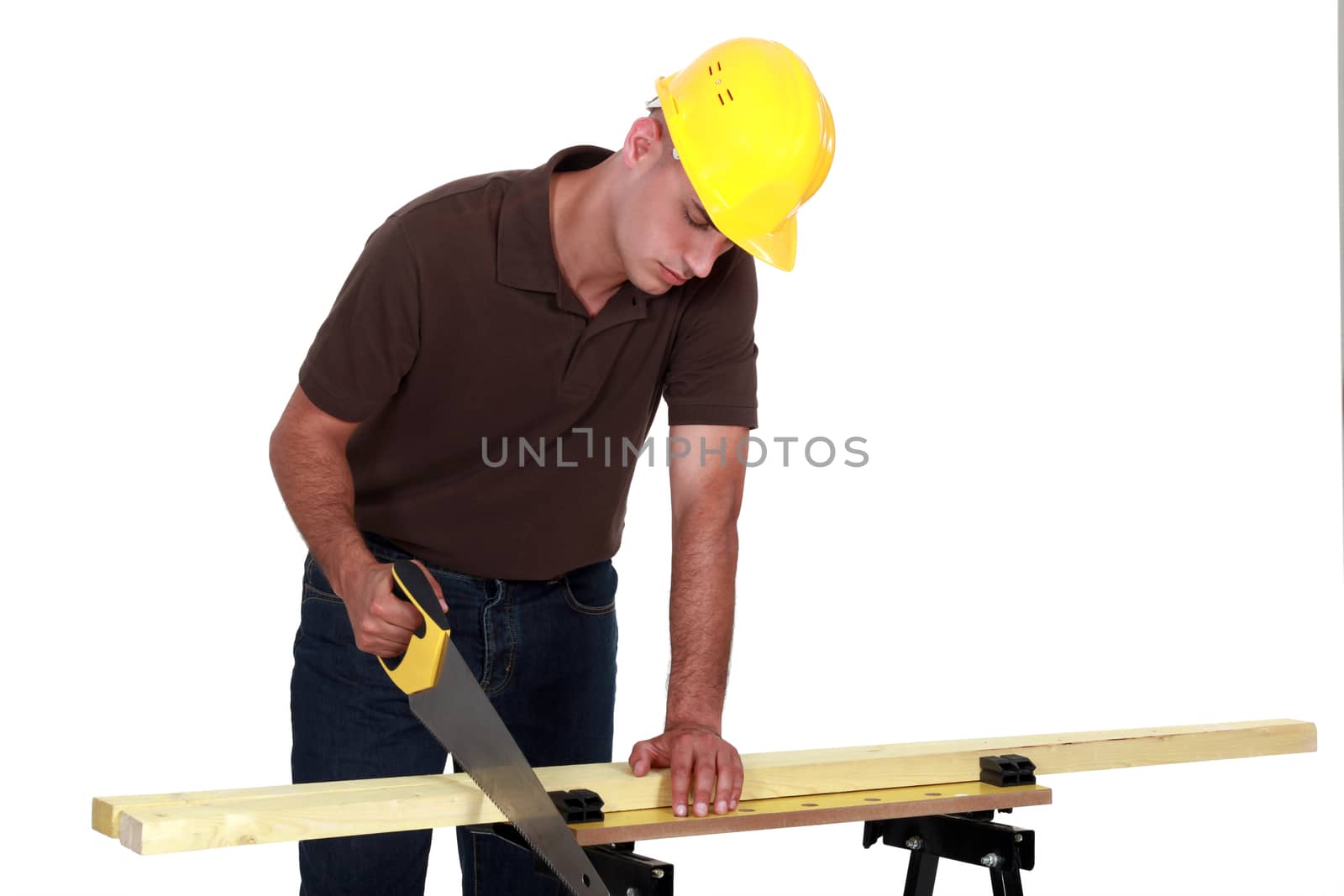 Tradesman sawing a piece of wood by phovoir