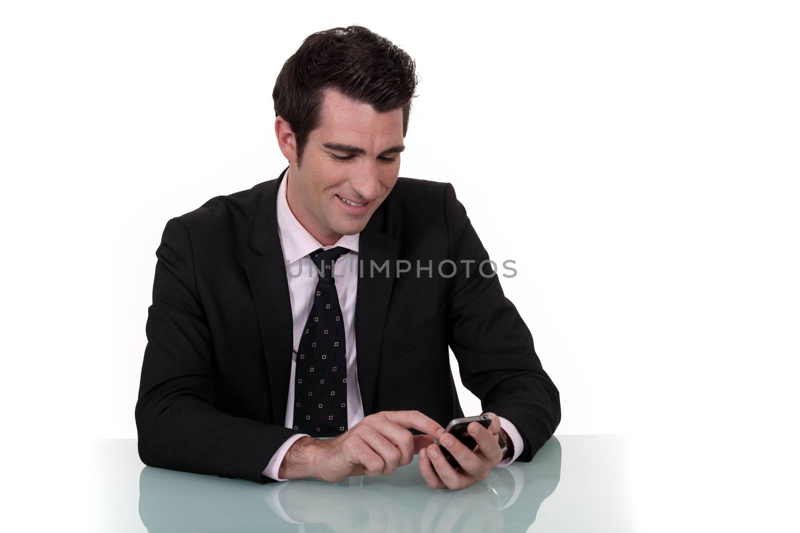 businessman amused at sms by phovoir