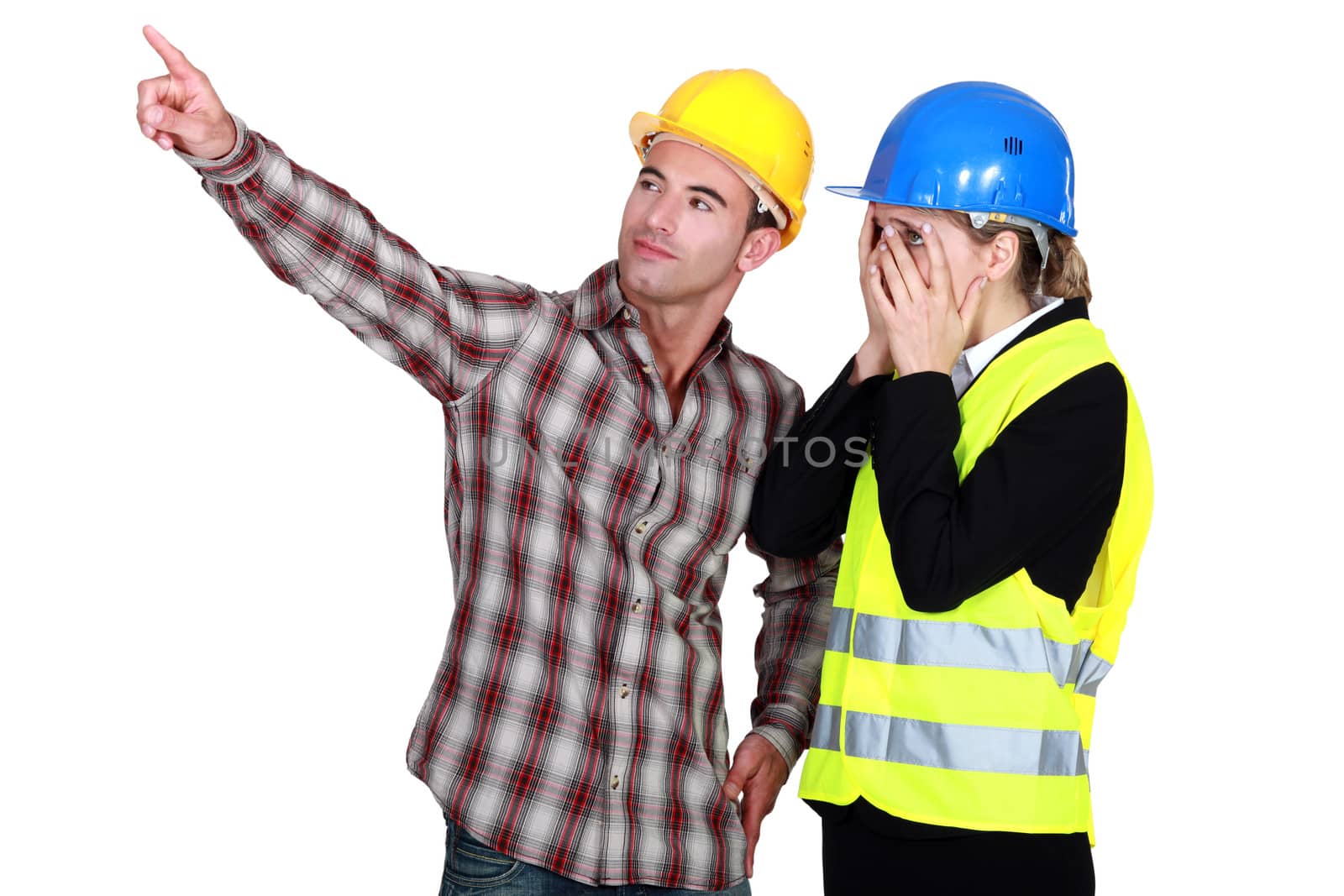 Construction couple discussing a problem by phovoir