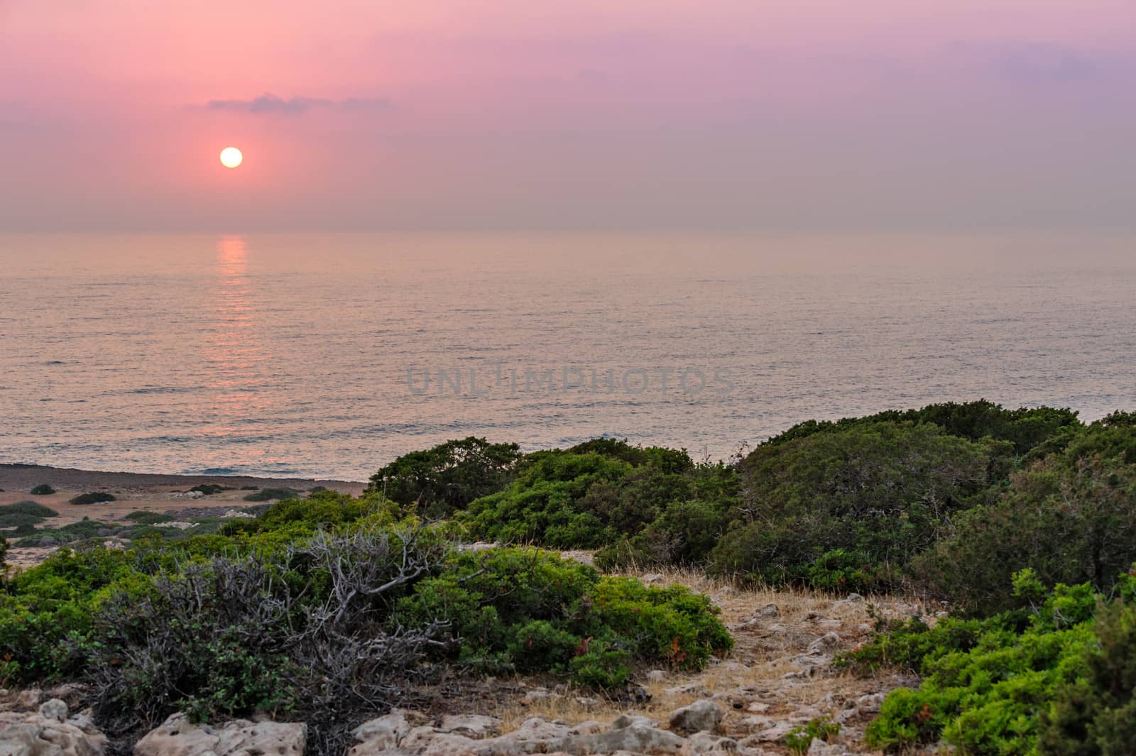 Landscape with seashore and sunset over sea