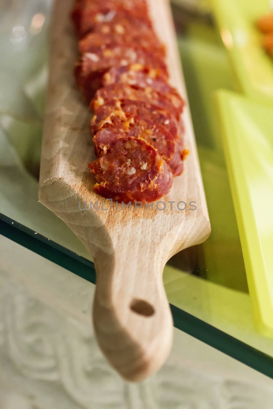 Close up of cut sausage over a wooden chopping board