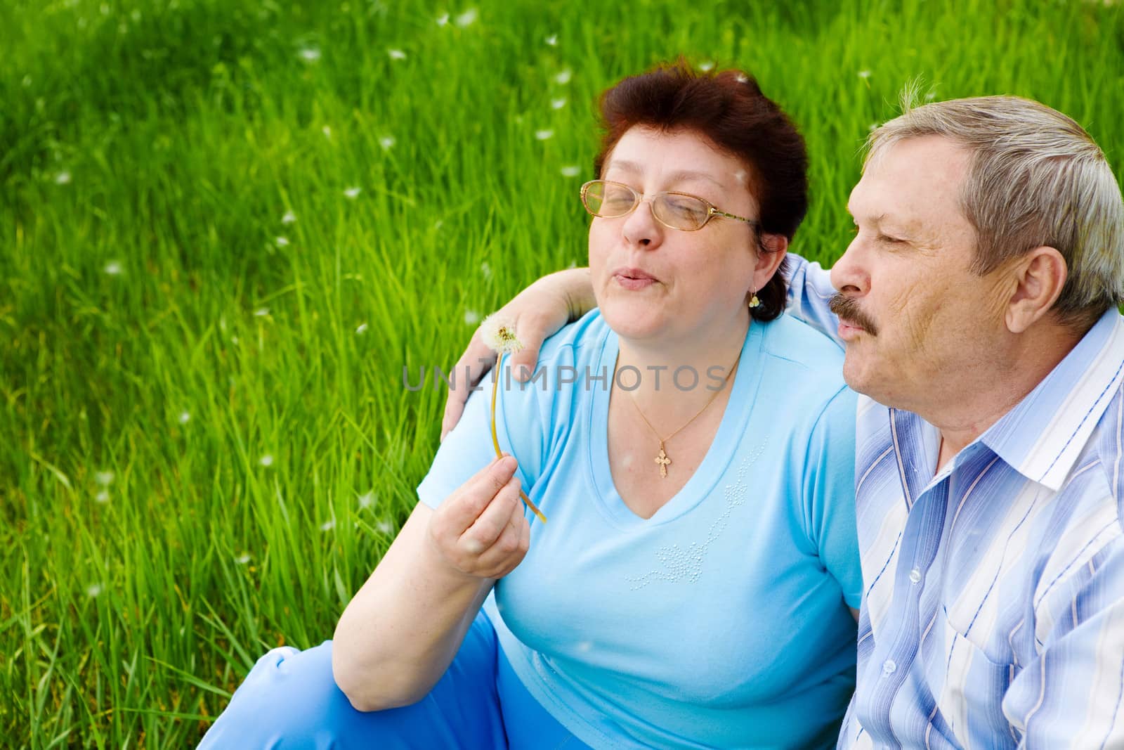 senior happy couple with dandelion