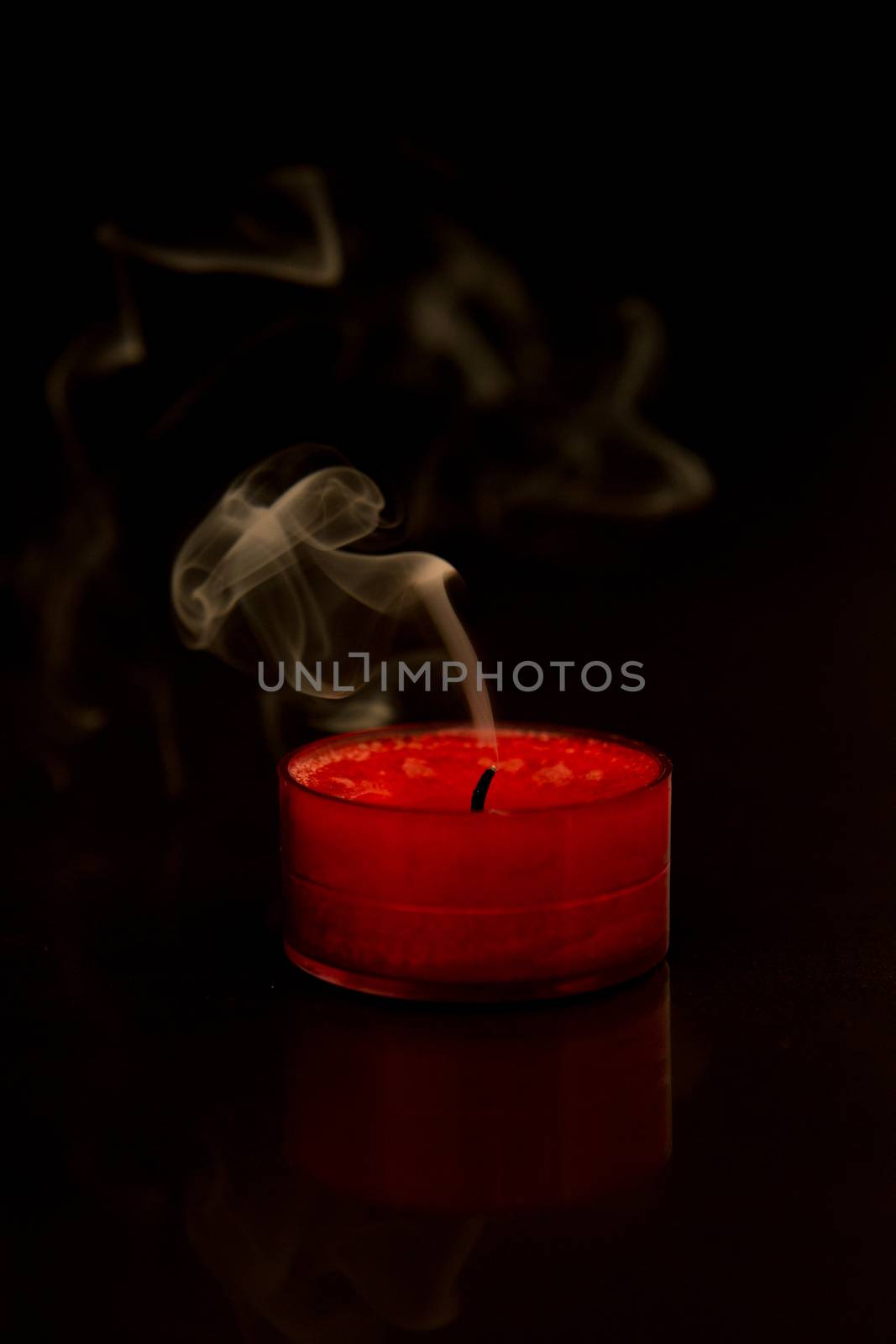 Burnt out candle on black background