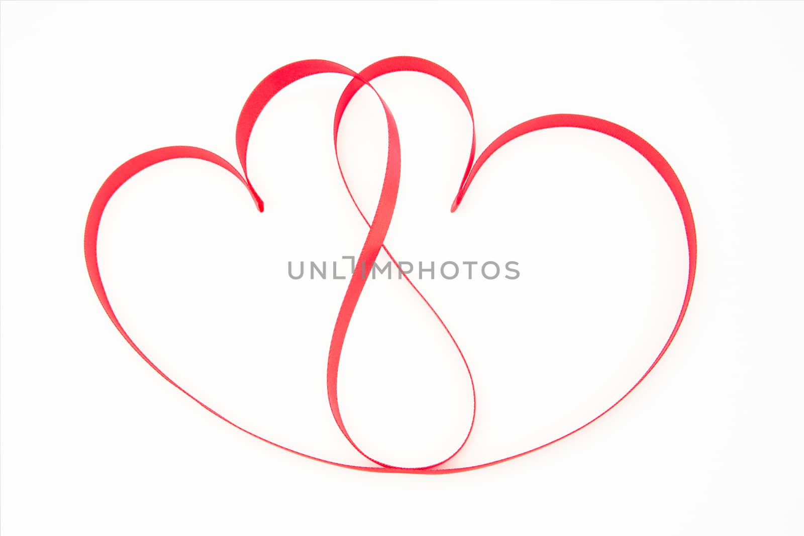 Pink ribbon shaped into intertwining hearts by Wavebreakmedia