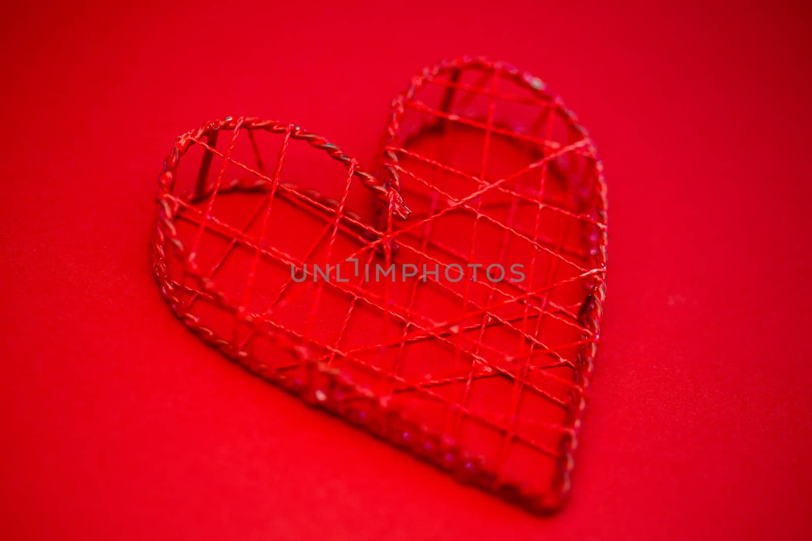 Heart shaped ornament box on red background