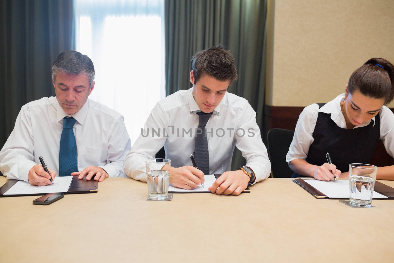 Business people in a meeting taking notes