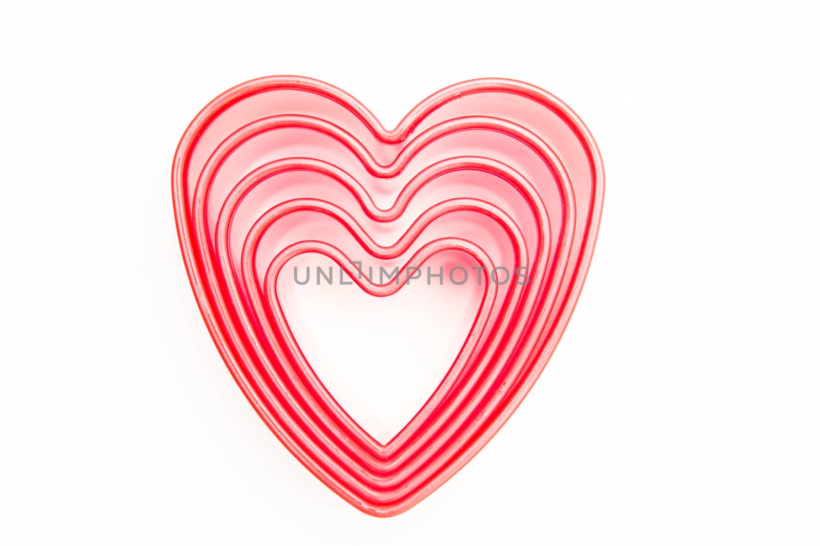 Pink heart cookie cutters on white background
