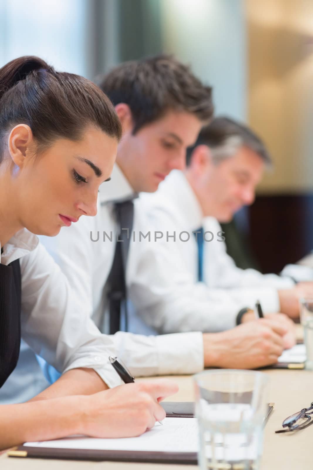 Concentrated business people taking notes in a meeting