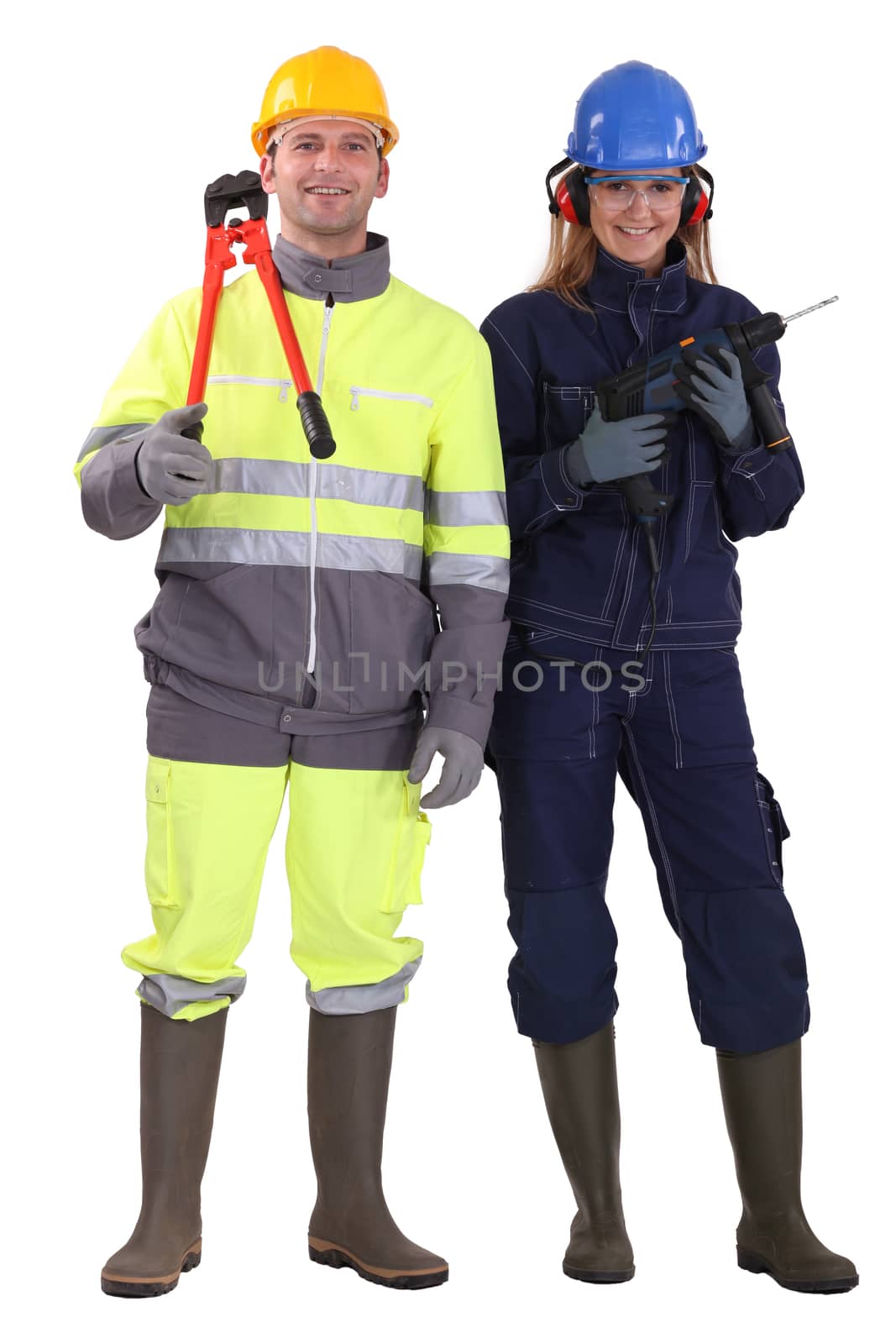 Man and woman with drill and pliers by phovoir