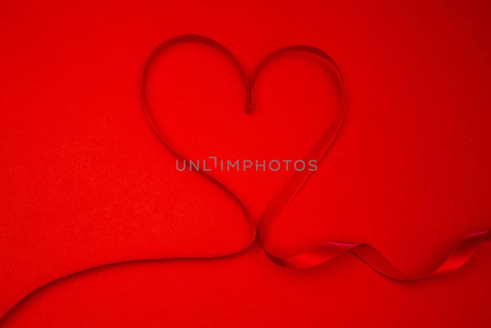 Ribbon shaped into a heart in red