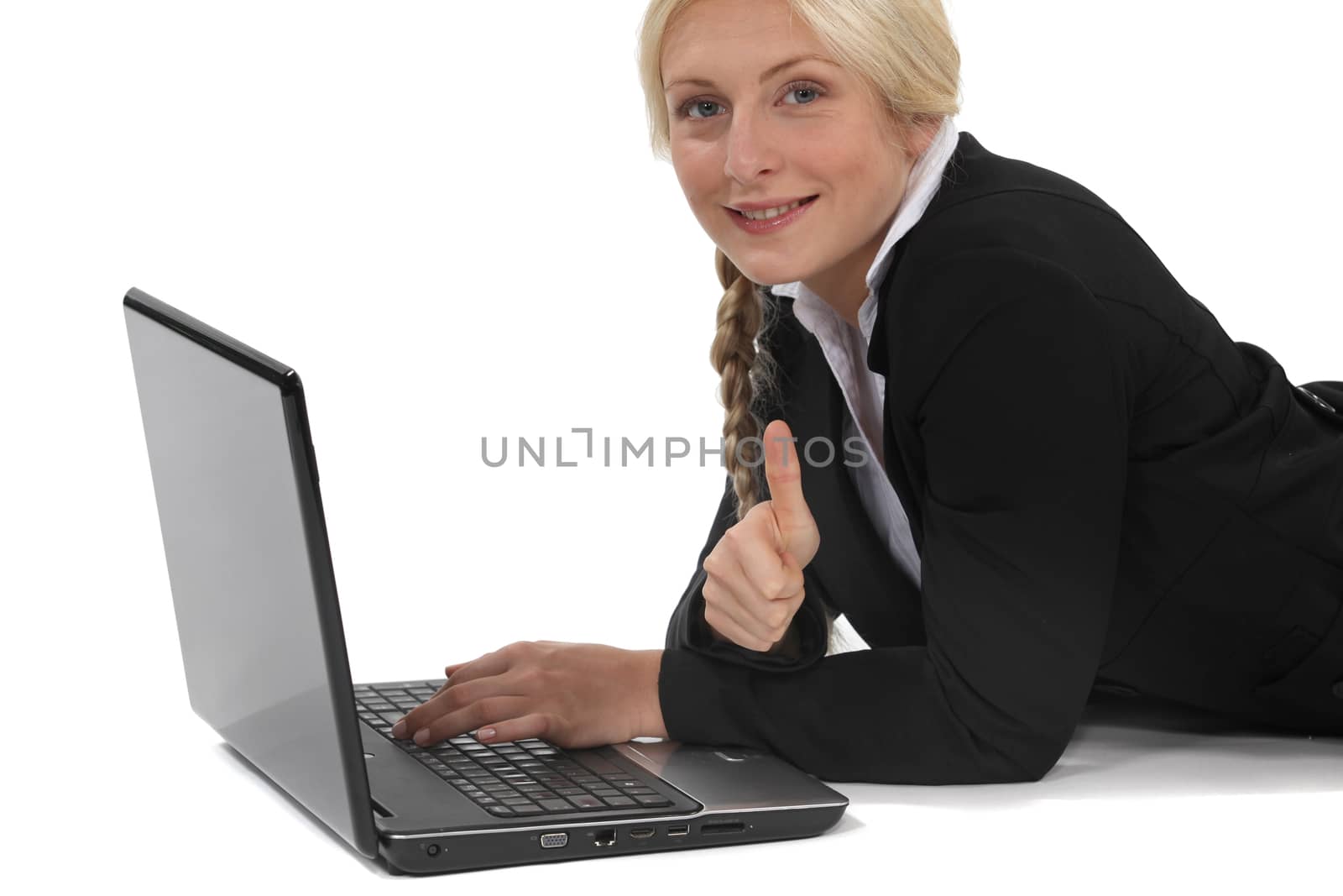 Woman lying in front of computer by phovoir