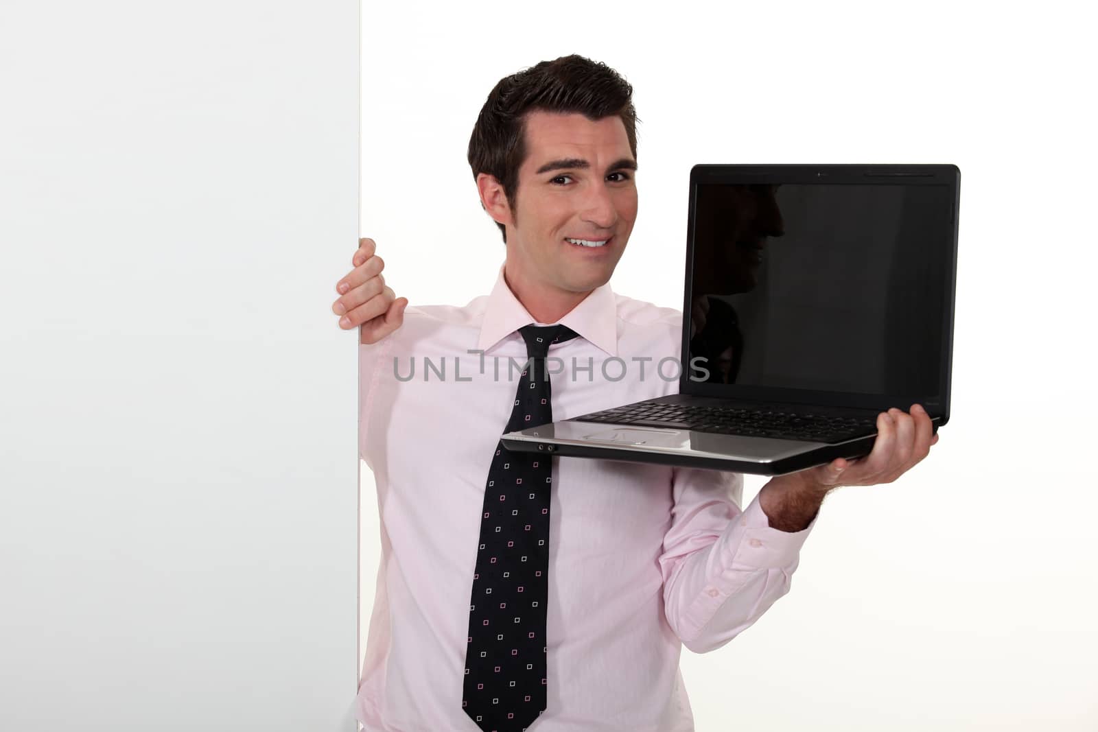 Man in smart suit showing notebook