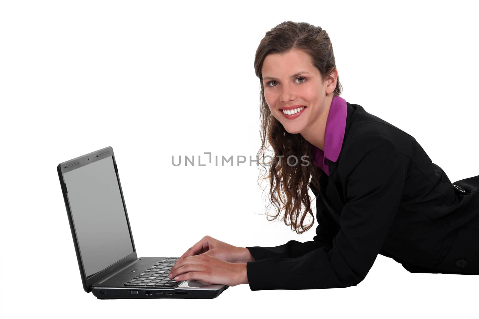 Businesswoman laying on the floor with her laptop.